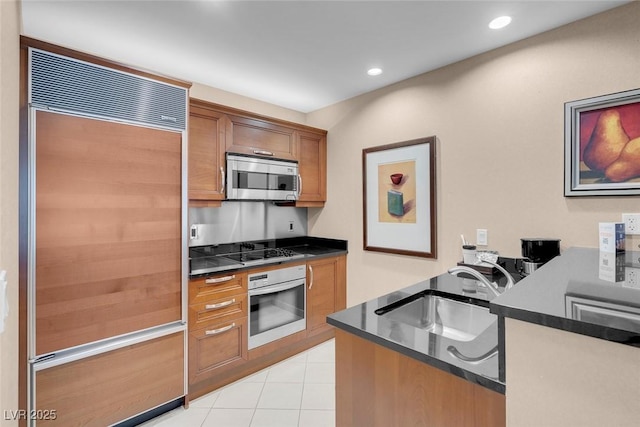 kitchen with sink, stainless steel appliances, and light tile patterned flooring