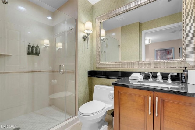 bathroom featuring vanity, walk in shower, and toilet