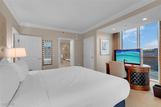 bedroom featuring ensuite bath and ornamental molding