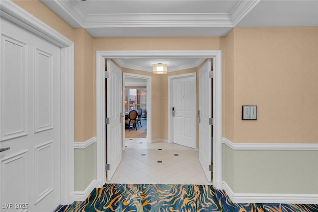 hallway featuring crown molding and light tile patterned floors