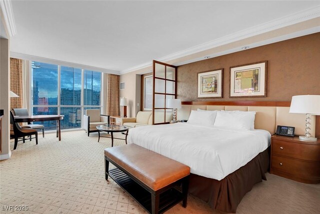 bedroom featuring crown molding and floor to ceiling windows