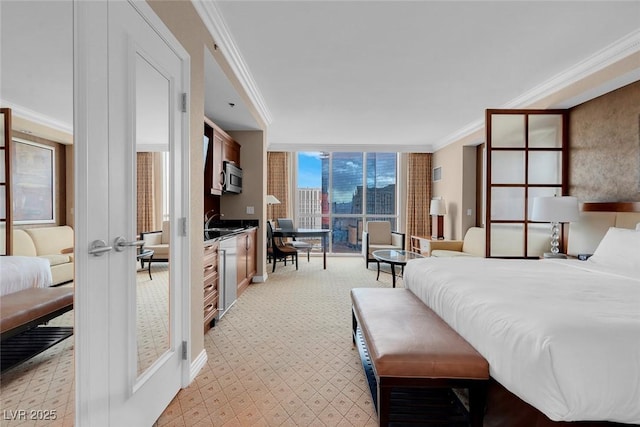 bedroom featuring french doors, ornamental molding, and sink