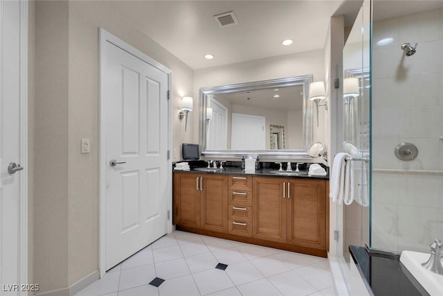 bathroom with tile patterned flooring, vanity, and a shower with shower door