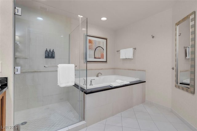 bathroom featuring tile patterned flooring and independent shower and bath