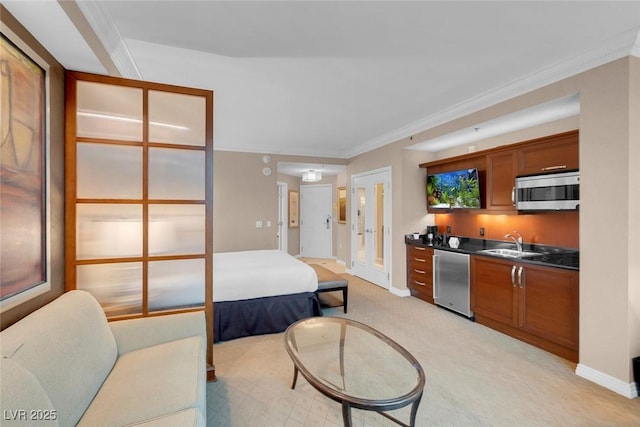 kitchen featuring sink, light colored carpet, ornamental molding, and appliances with stainless steel finishes