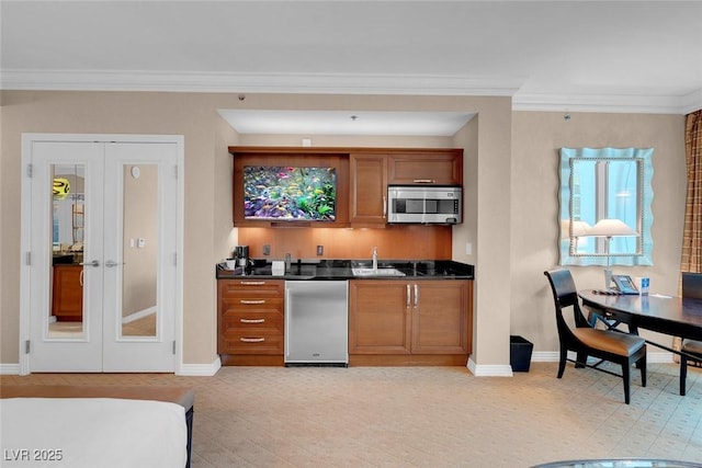 kitchen with ornamental molding, sink, refrigerator, and french doors