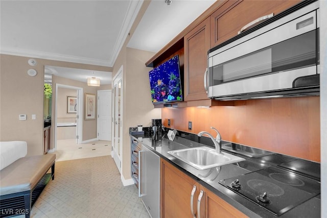 kitchen featuring crown molding, sink, and black electric stovetop