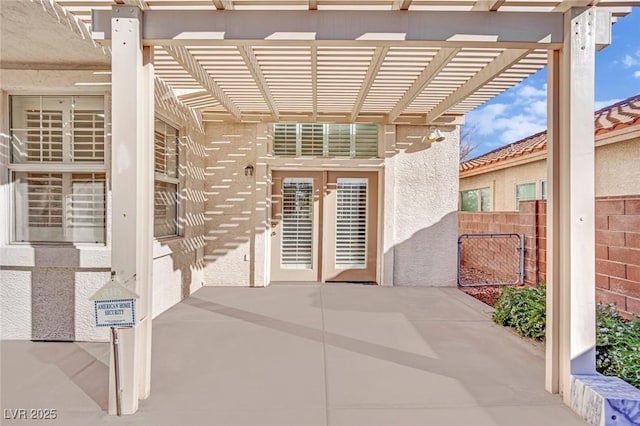 view of exterior entry featuring a pergola