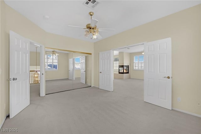 carpeted spare room featuring ceiling fan