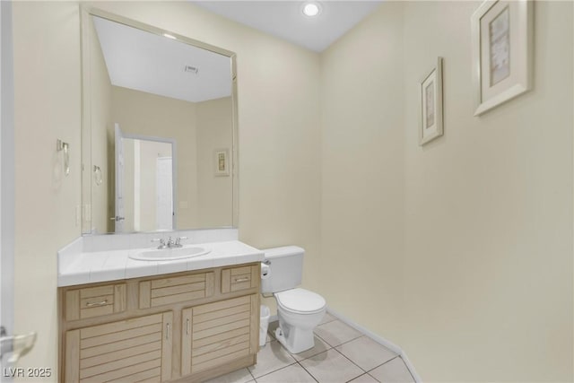 bathroom featuring vanity, tile patterned floors, and toilet