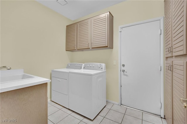 laundry area featuring cabinets, light tile patterned flooring, sink, and independent washer and dryer