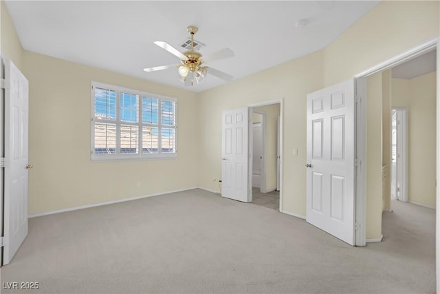 unfurnished bedroom with ceiling fan and light colored carpet