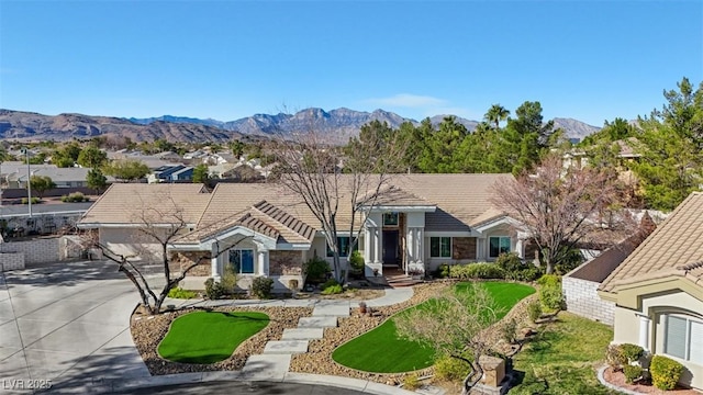 ranch-style house with a mountain view and a front yard