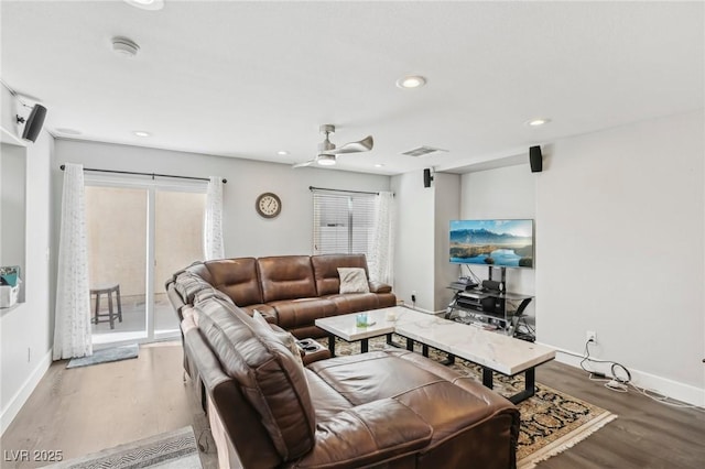 living room with light wood-type flooring and ceiling fan