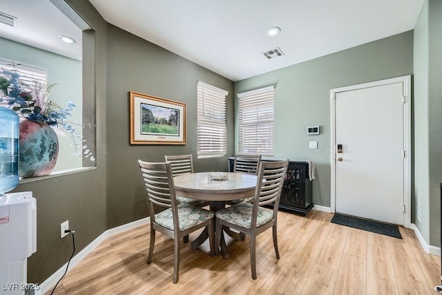 dining area featuring light hardwood / wood-style flooring and a healthy amount of sunlight