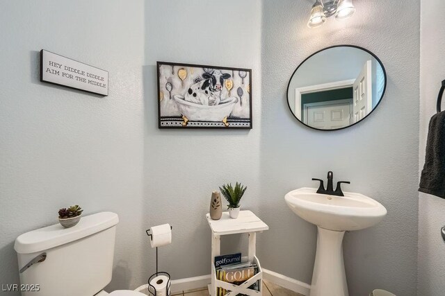 bathroom featuring toilet and tile patterned flooring