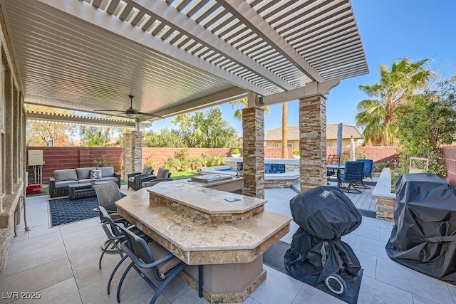 view of patio with ceiling fan, a grill, exterior bar, an outdoor hangout area, and a pergola