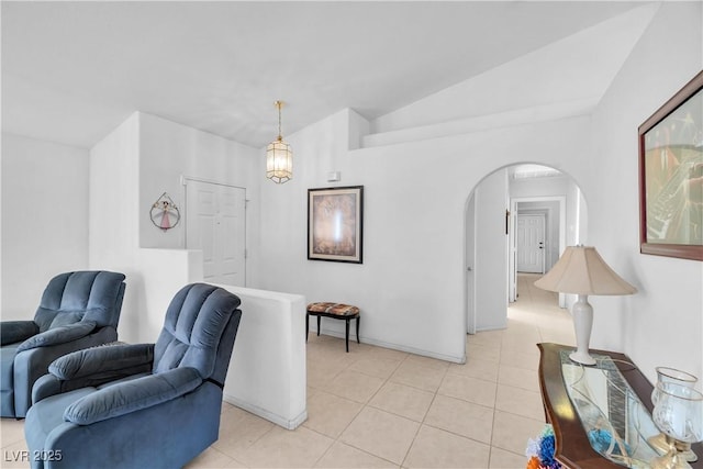 tiled living room featuring lofted ceiling