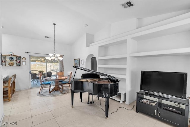 miscellaneous room featuring vaulted ceiling, a chandelier, light tile patterned flooring, and built in features