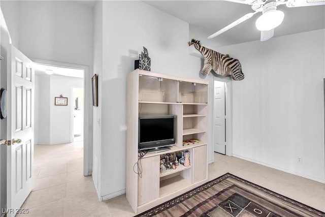 tiled living room featuring ceiling fan