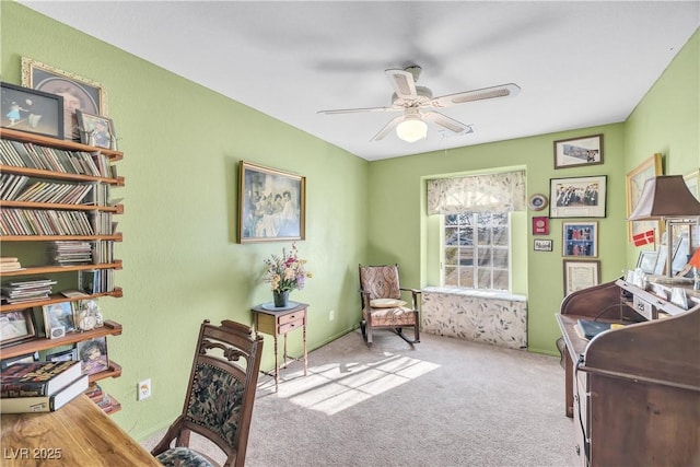 interior space with ceiling fan and light colored carpet