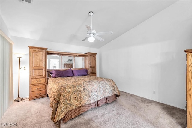 carpeted bedroom with ceiling fan and vaulted ceiling