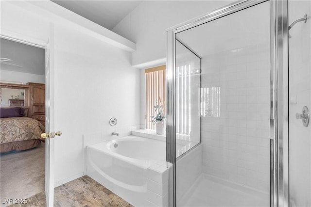 bathroom with hardwood / wood-style flooring and plus walk in shower