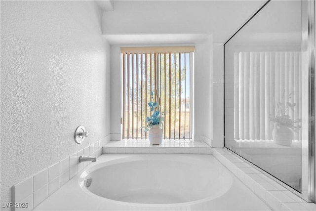 bathroom with a tub to relax in