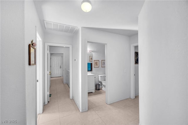 hall with light tile patterned floors