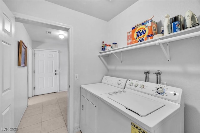 laundry room with separate washer and dryer and light tile patterned floors