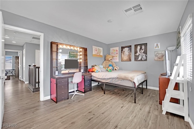 bedroom featuring light hardwood / wood-style floors and multiple windows