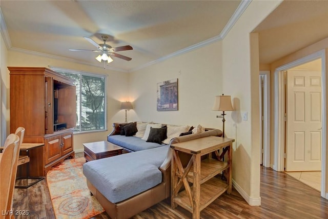 living room featuring ceiling fan, ornamental molding, and dark hardwood / wood-style flooring