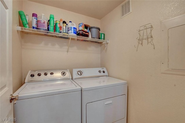 washroom featuring washer and clothes dryer and electric panel