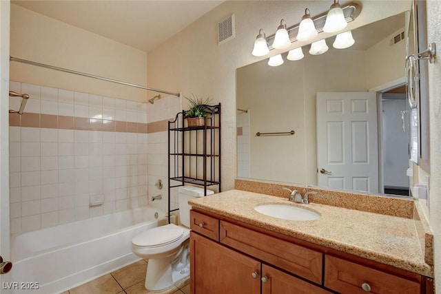 full bathroom featuring toilet, tiled shower / bath combo, tile patterned floors, and vanity