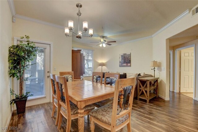 dining area featuring ceiling fan with notable chandelier, plenty of natural light, wood-type flooring, and ornamental molding