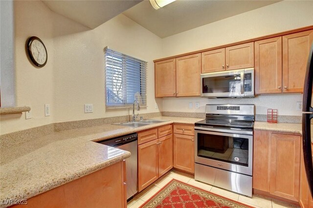 kitchen featuring light tile patterned flooring, appliances with stainless steel finishes, and sink