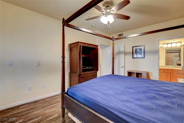 bedroom with ensuite bath, ceiling fan, and dark wood-type flooring