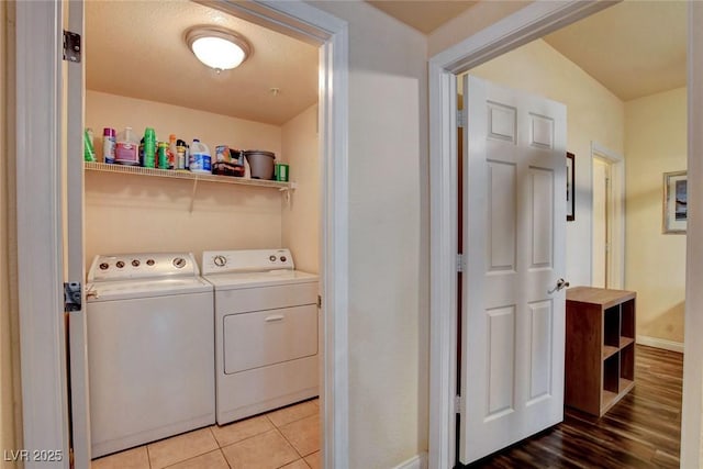 washroom featuring light tile patterned floors and washing machine and clothes dryer