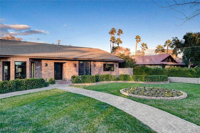 ranch-style home featuring a front yard