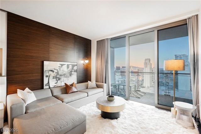 living room with floor to ceiling windows and wooden walls