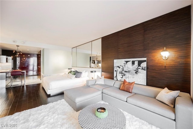 living room featuring dark hardwood / wood-style floors and a notable chandelier