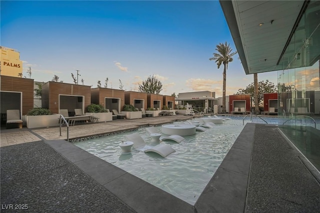 pool at dusk with a patio