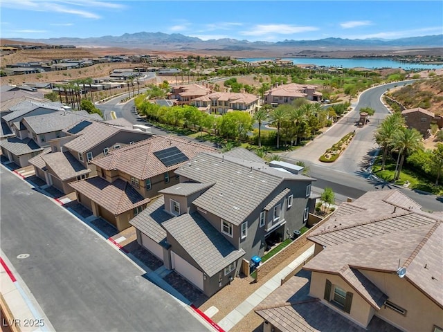 birds eye view of property featuring a water and mountain view