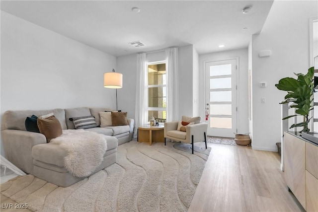 living room with light hardwood / wood-style flooring