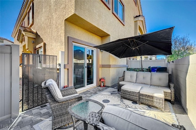 view of patio with outdoor lounge area and a fenced backyard