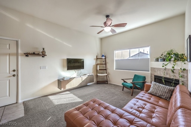 living room featuring ceiling fan, a fireplace, and light colored carpet