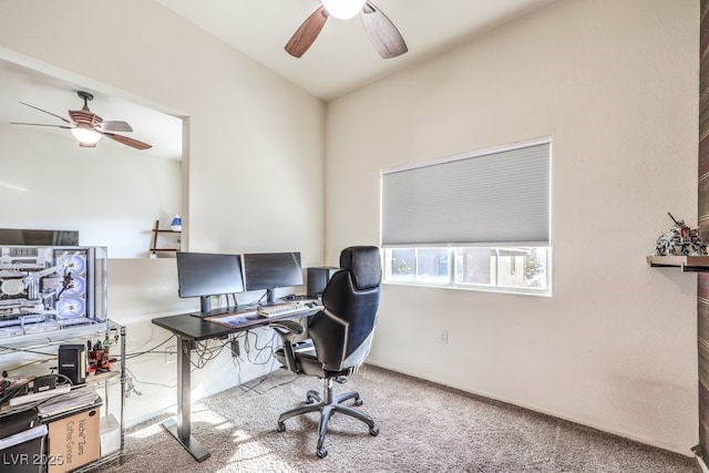 carpeted office space featuring vaulted ceiling and ceiling fan