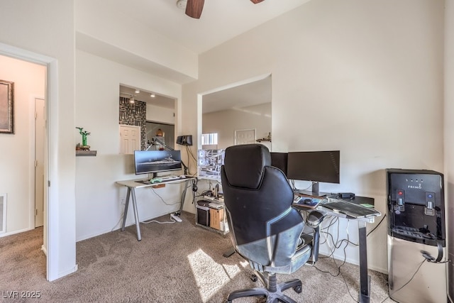 carpeted office featuring ceiling fan