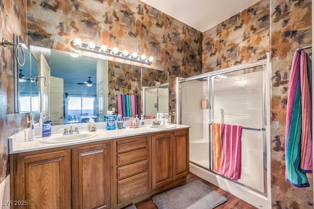 bathroom with ceiling fan, wood-type flooring, an enclosed shower, and vanity