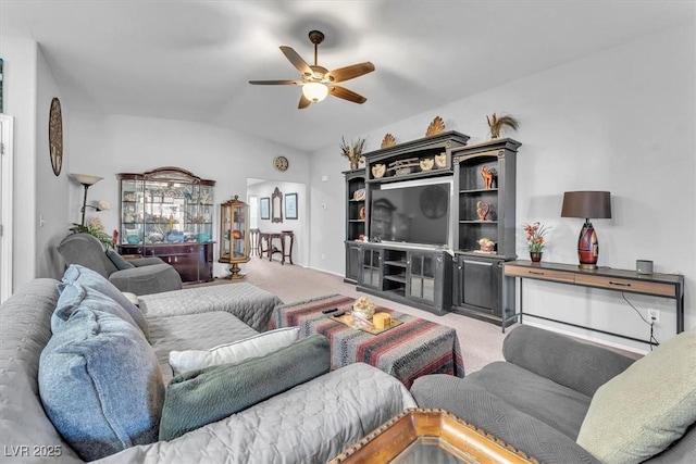 carpeted living room featuring vaulted ceiling and ceiling fan